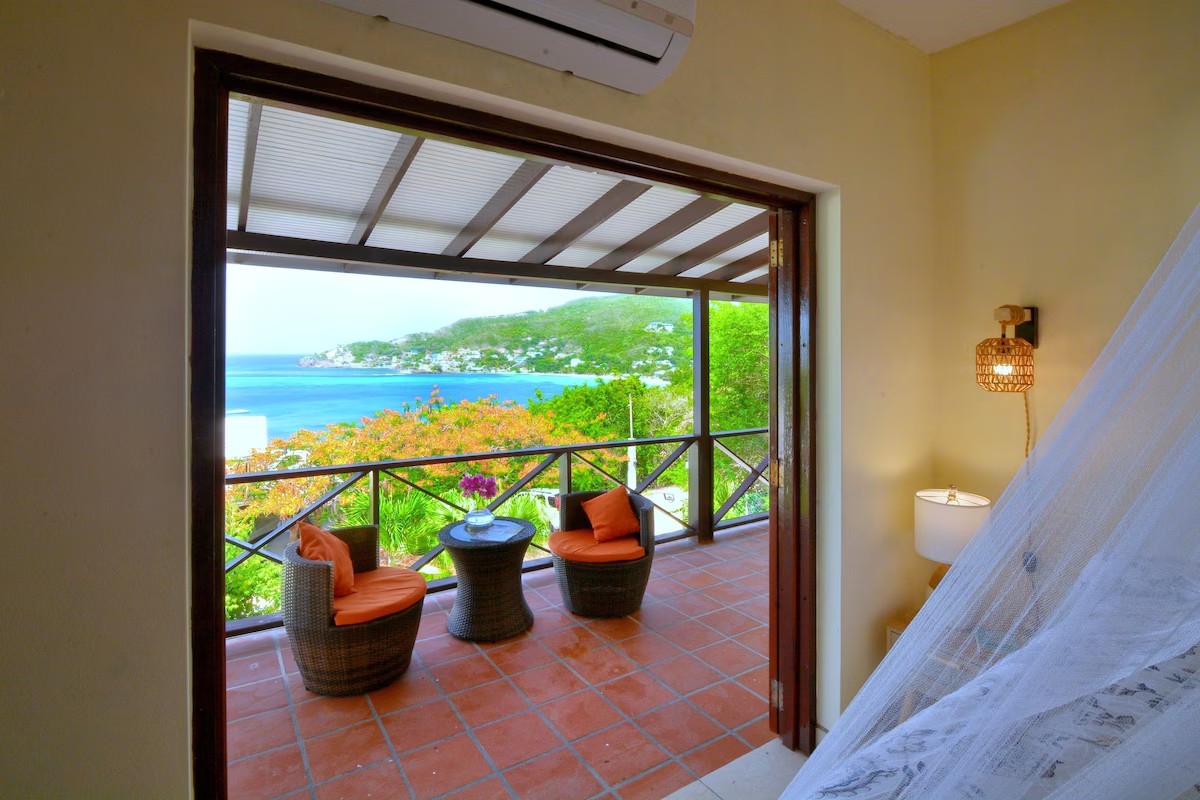 Villa Marisol bedroom with private balcony and Caribbean bay view