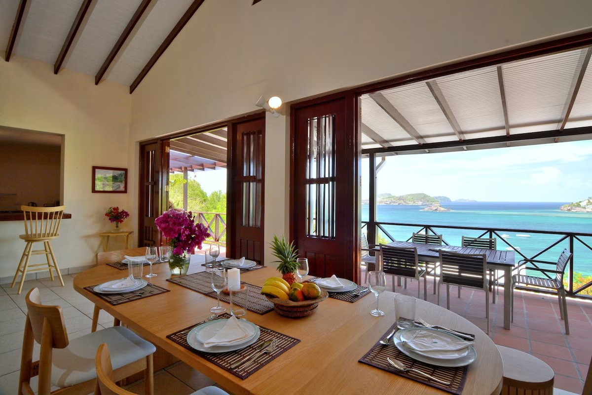 Villa Marisol dining table set for guests with turquoise bay view